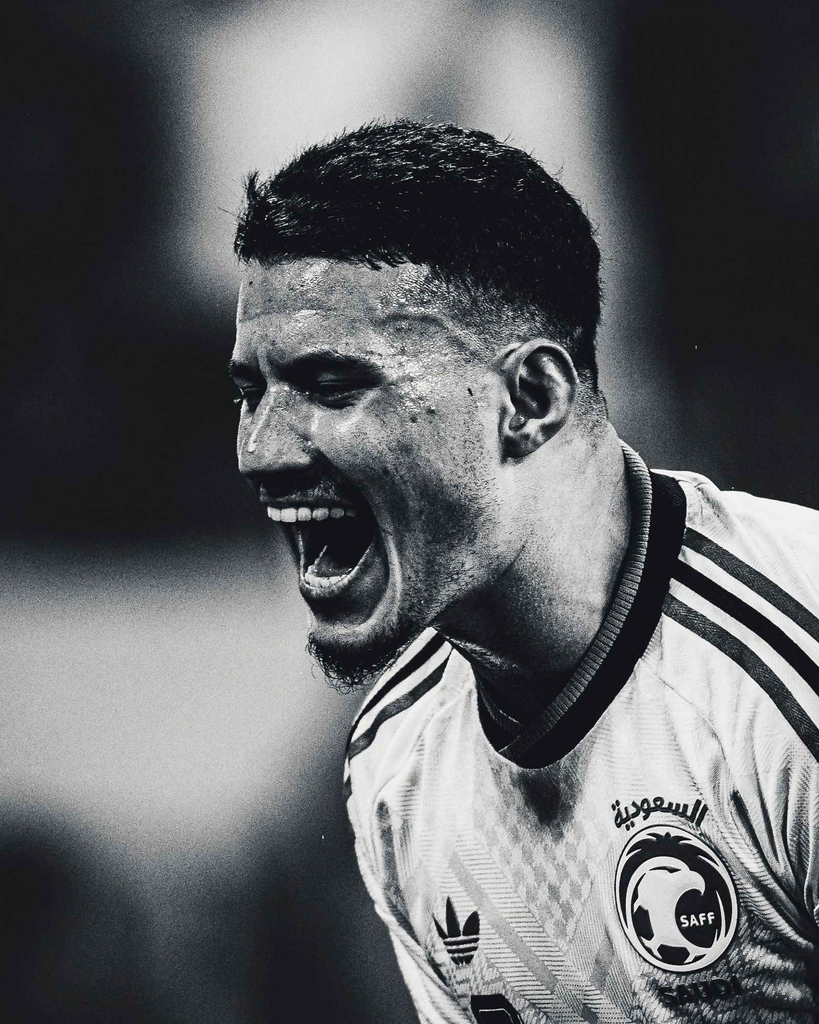 Black and white portrait of a soccer player screaming in celebration