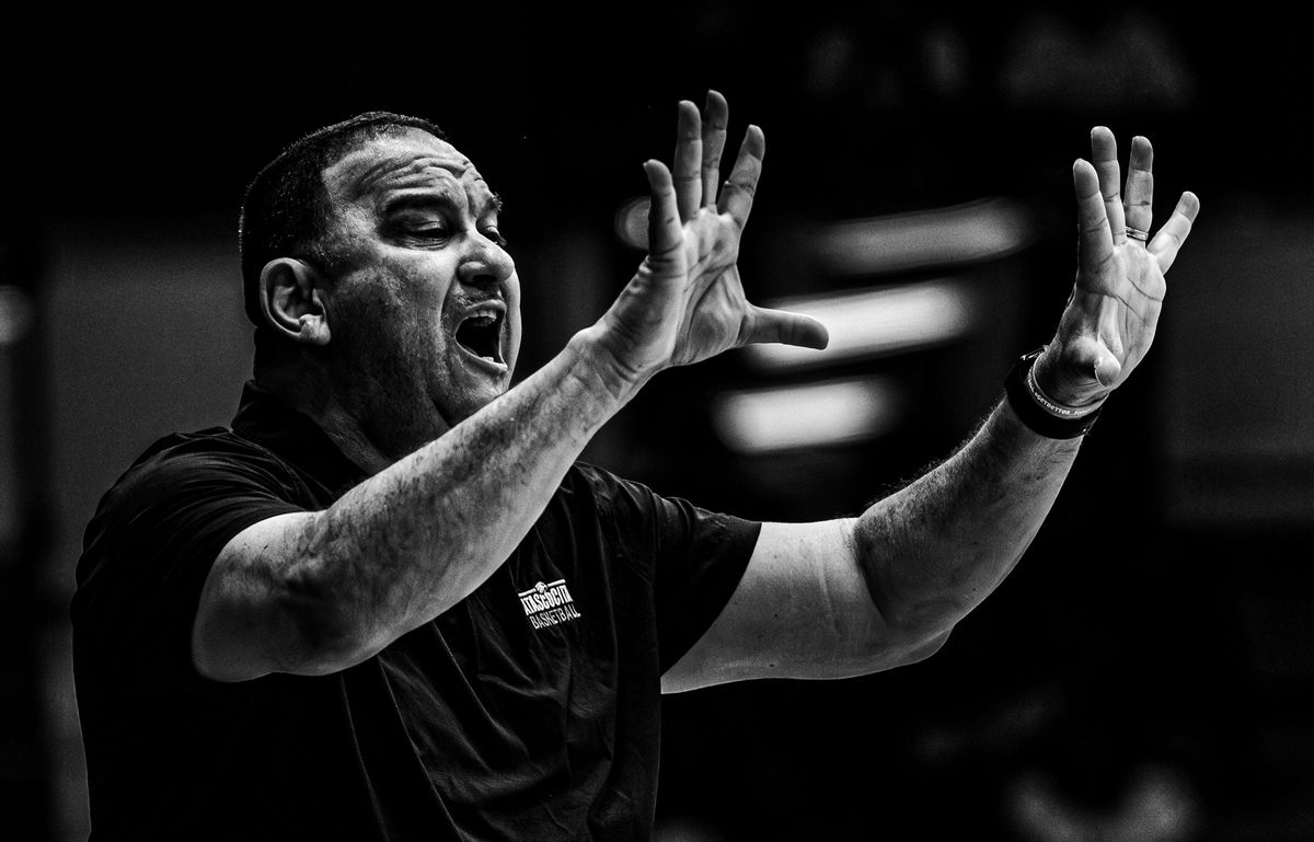 Coach shouting instructions from the sideline, black and white