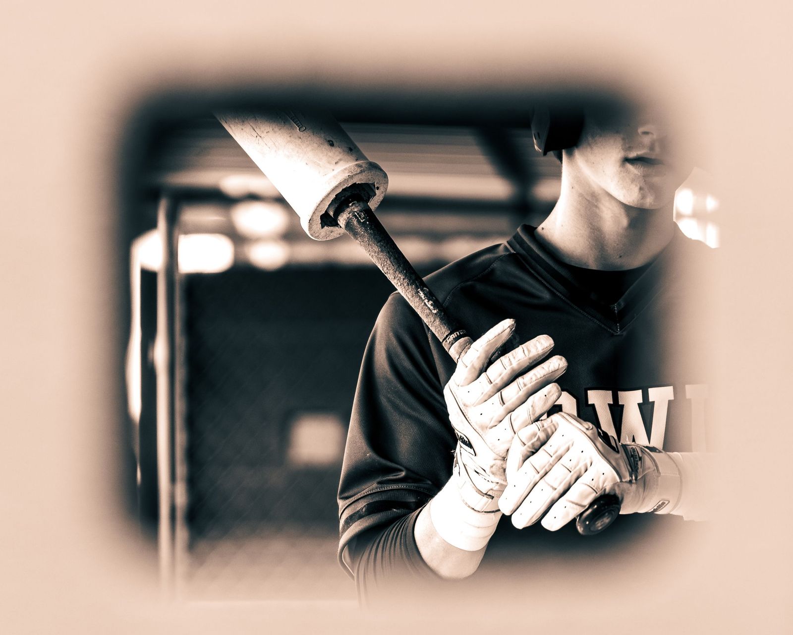 Batting gloves wrapped around a bat, sepia