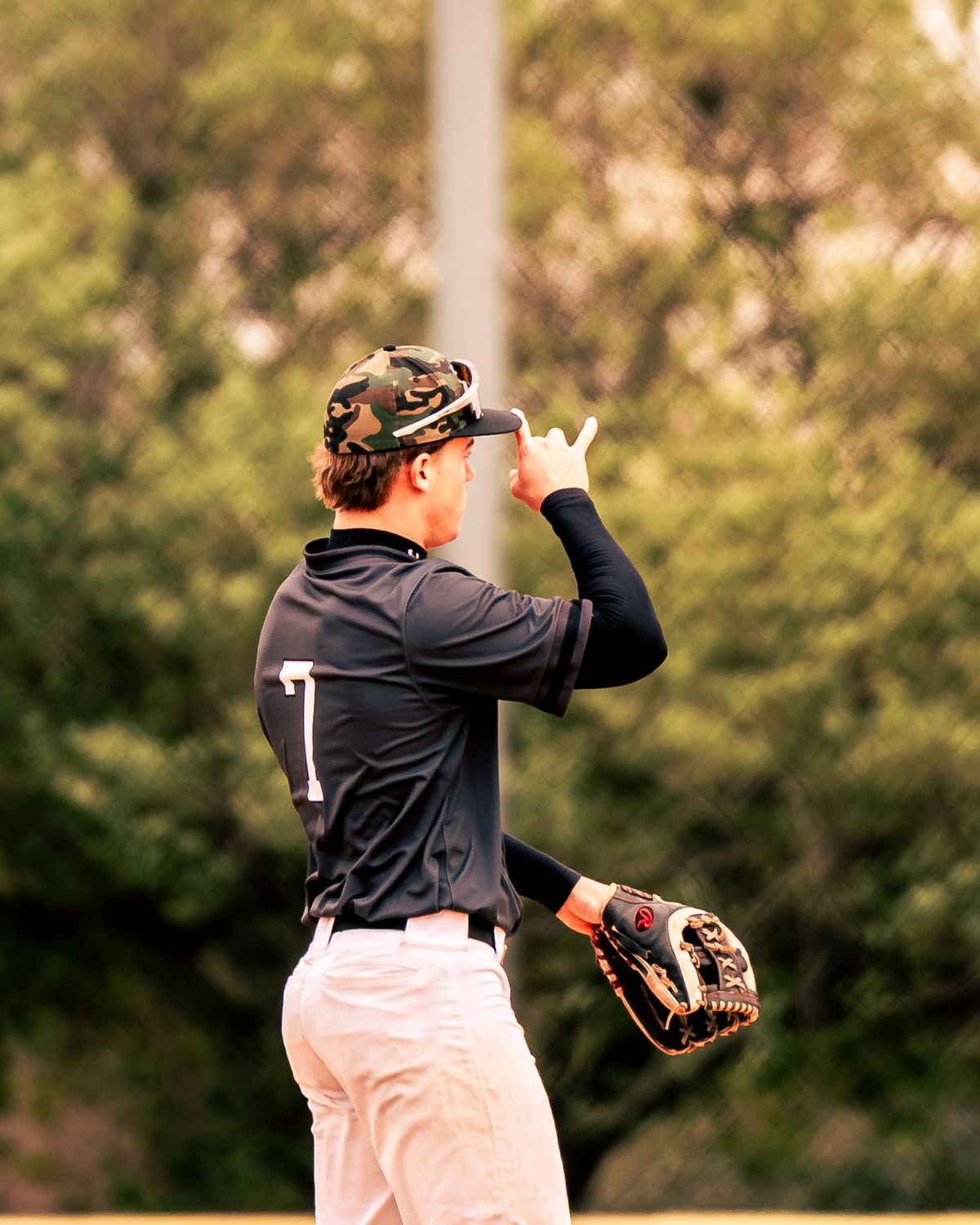 Baseball player tipping his cap on the field