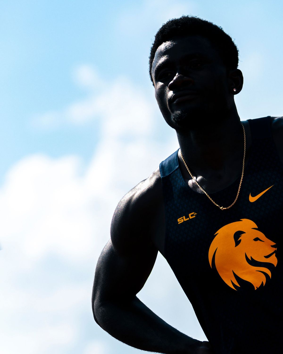 Runner in a lion crest tank top looking up before a race