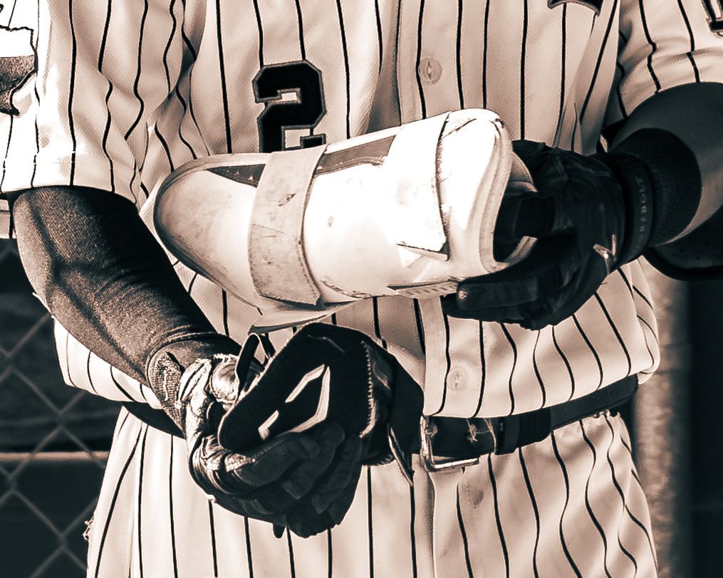 Player tightening his batting gloves, black and white
