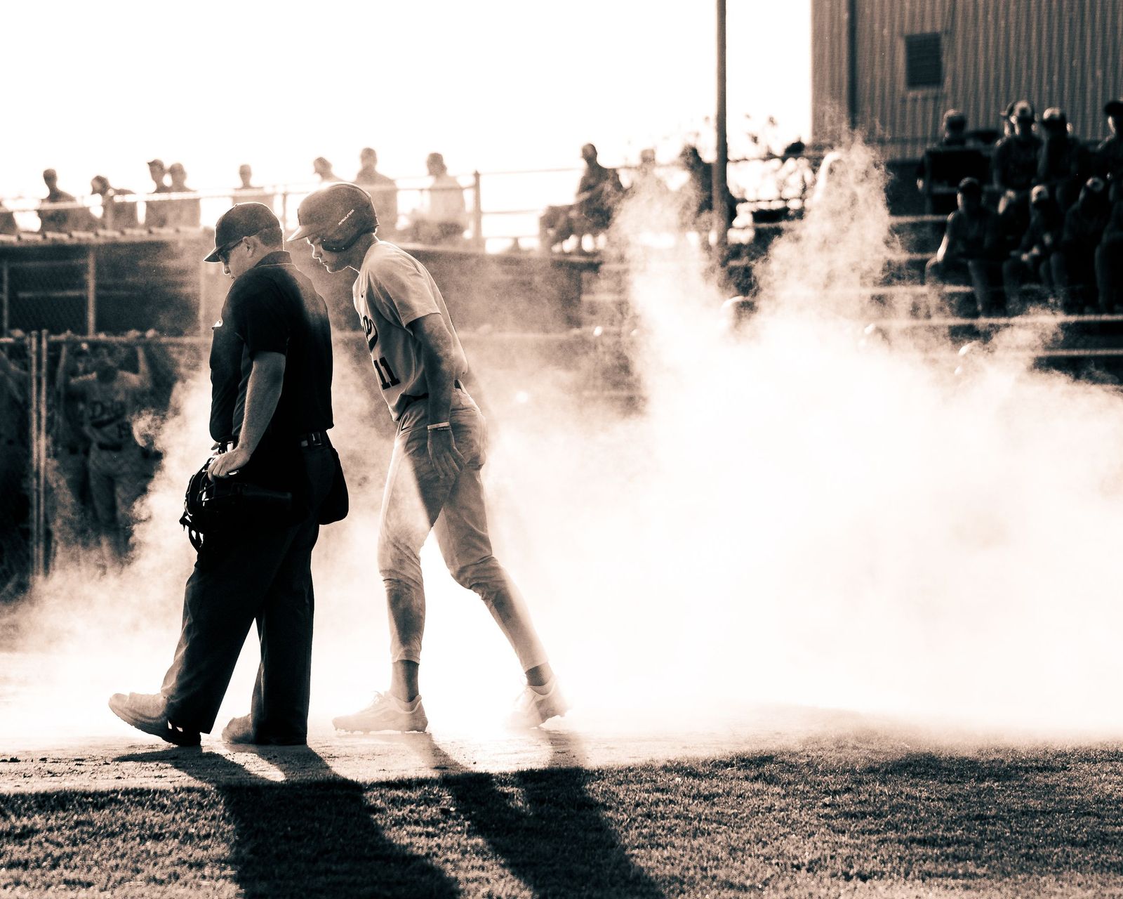 Runner sliding into base in a cloud of dust