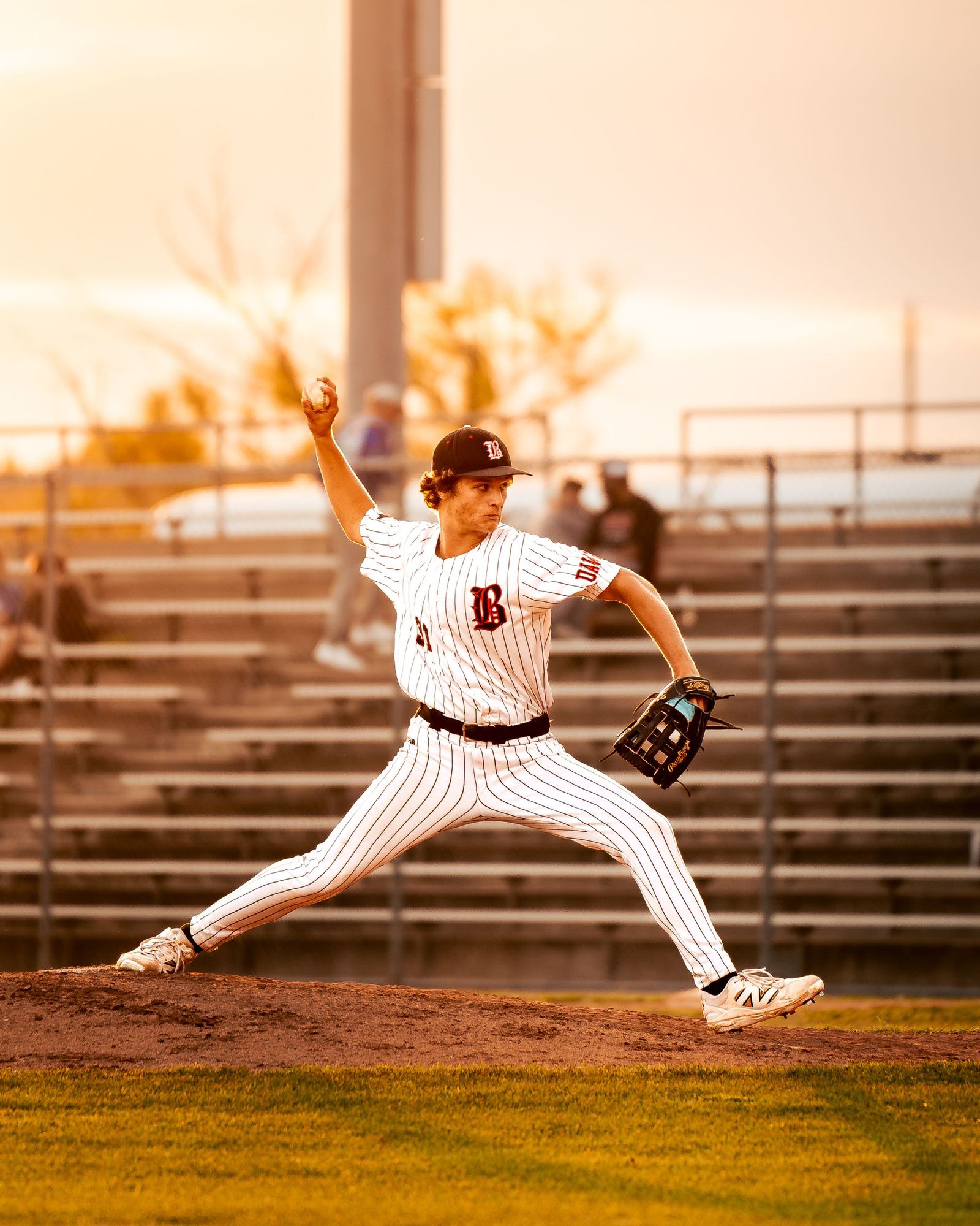Pitcher in full stride at sunset
