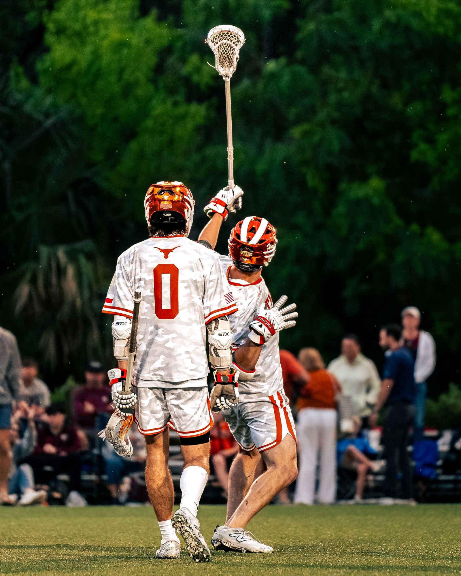 Lacrosse teammates celebrating a goal