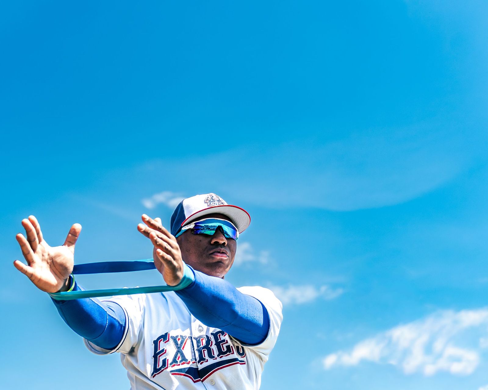 Round Rock Express player catching a ball against a blue sky