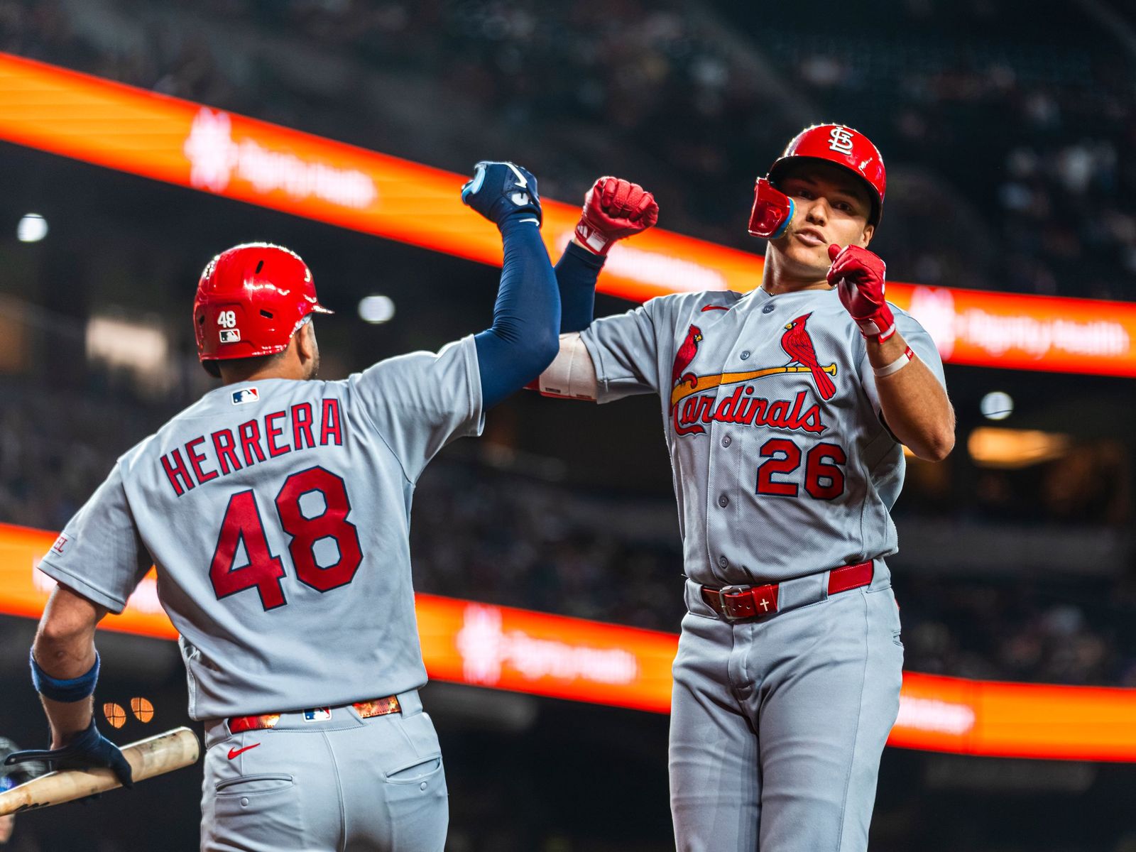 Cardinals teammates high-fiving after a run