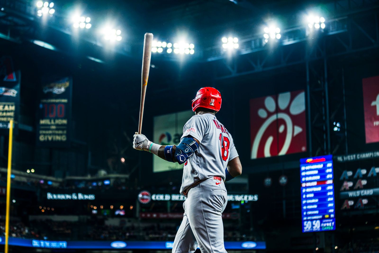 Cardinals batter walking to the plate at night