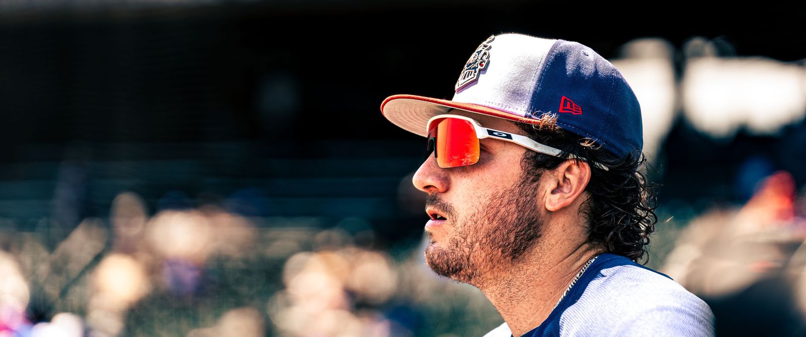 Round Rock Express player in sunglasses watching from the dugout