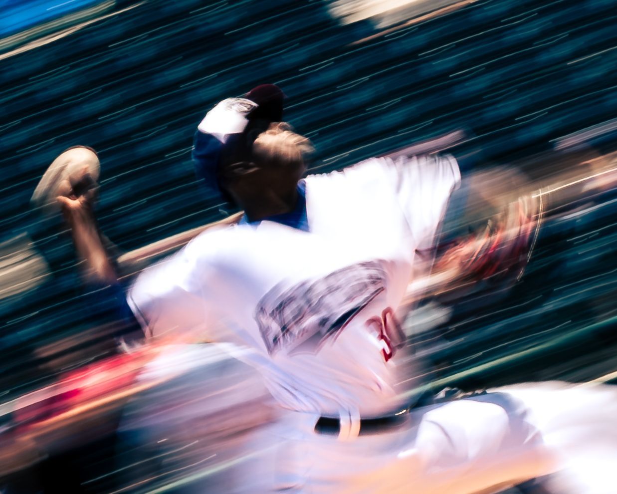Pitcher in a motion blur mid-delivery
