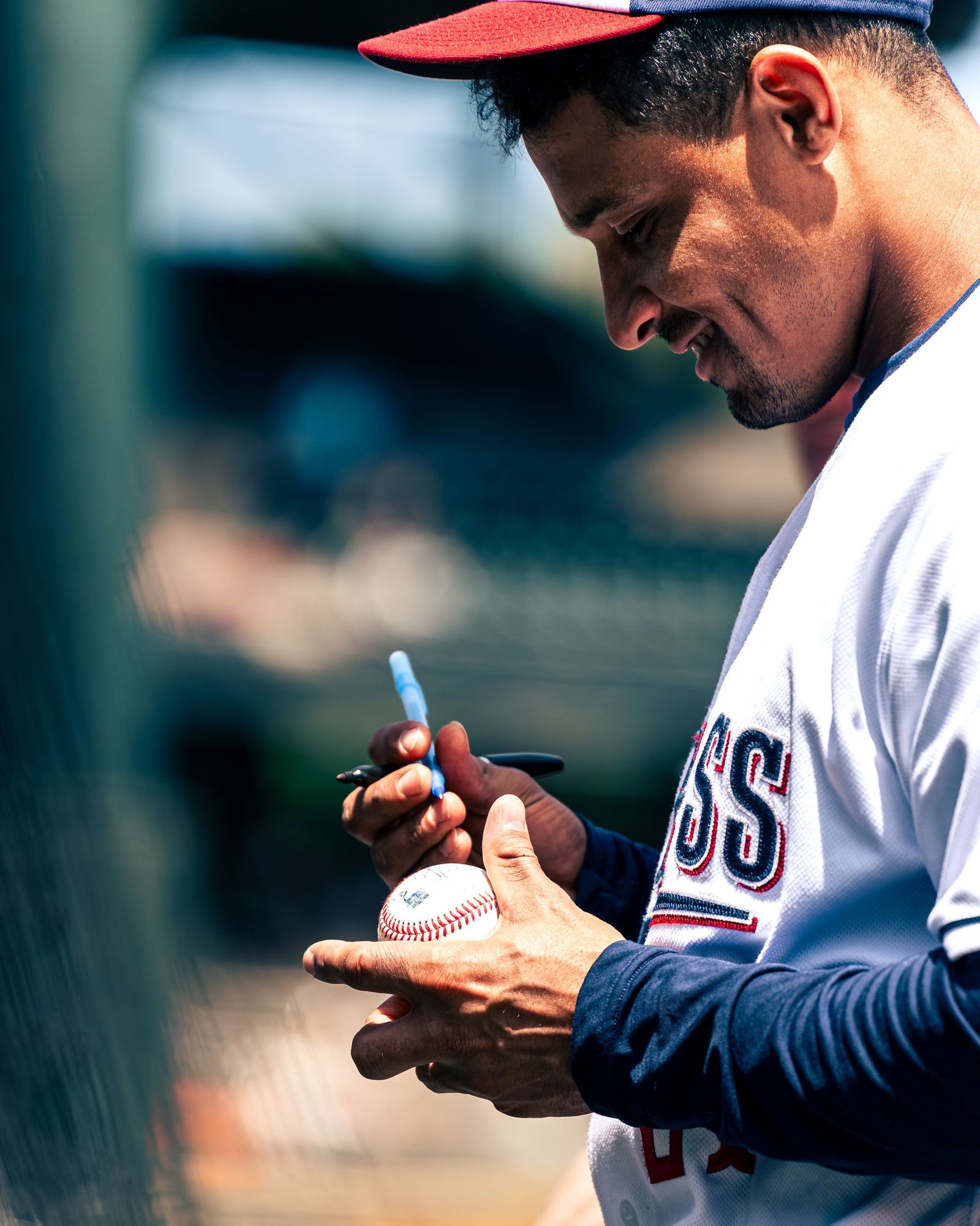 Round Rock Express player signing a baseball