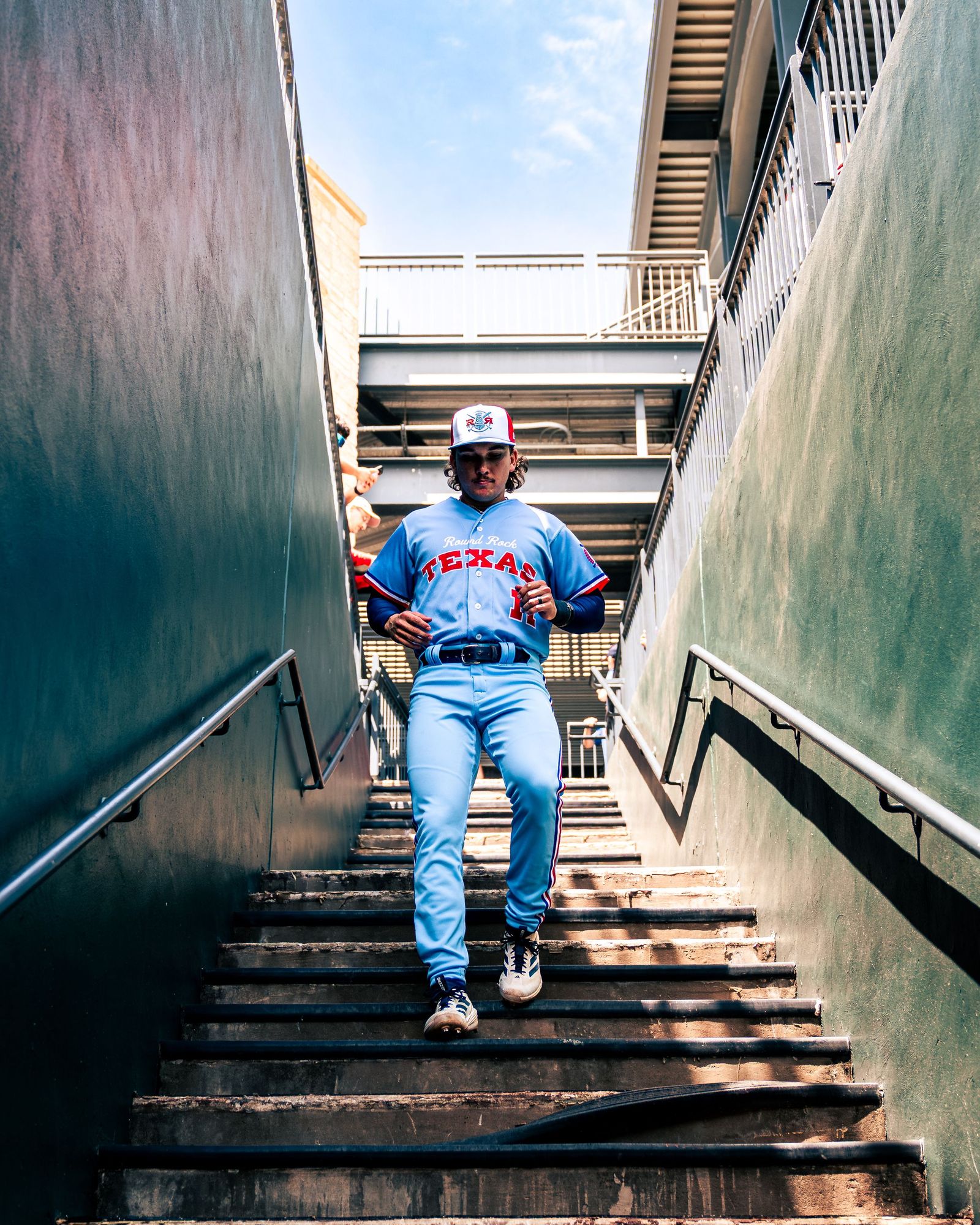 Player in light blue walking down the stadium stairs
