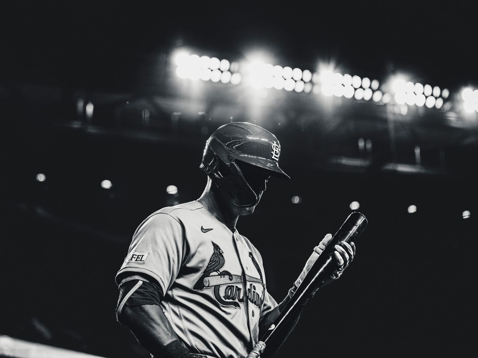 Cardinals player under stadium lights, black and white