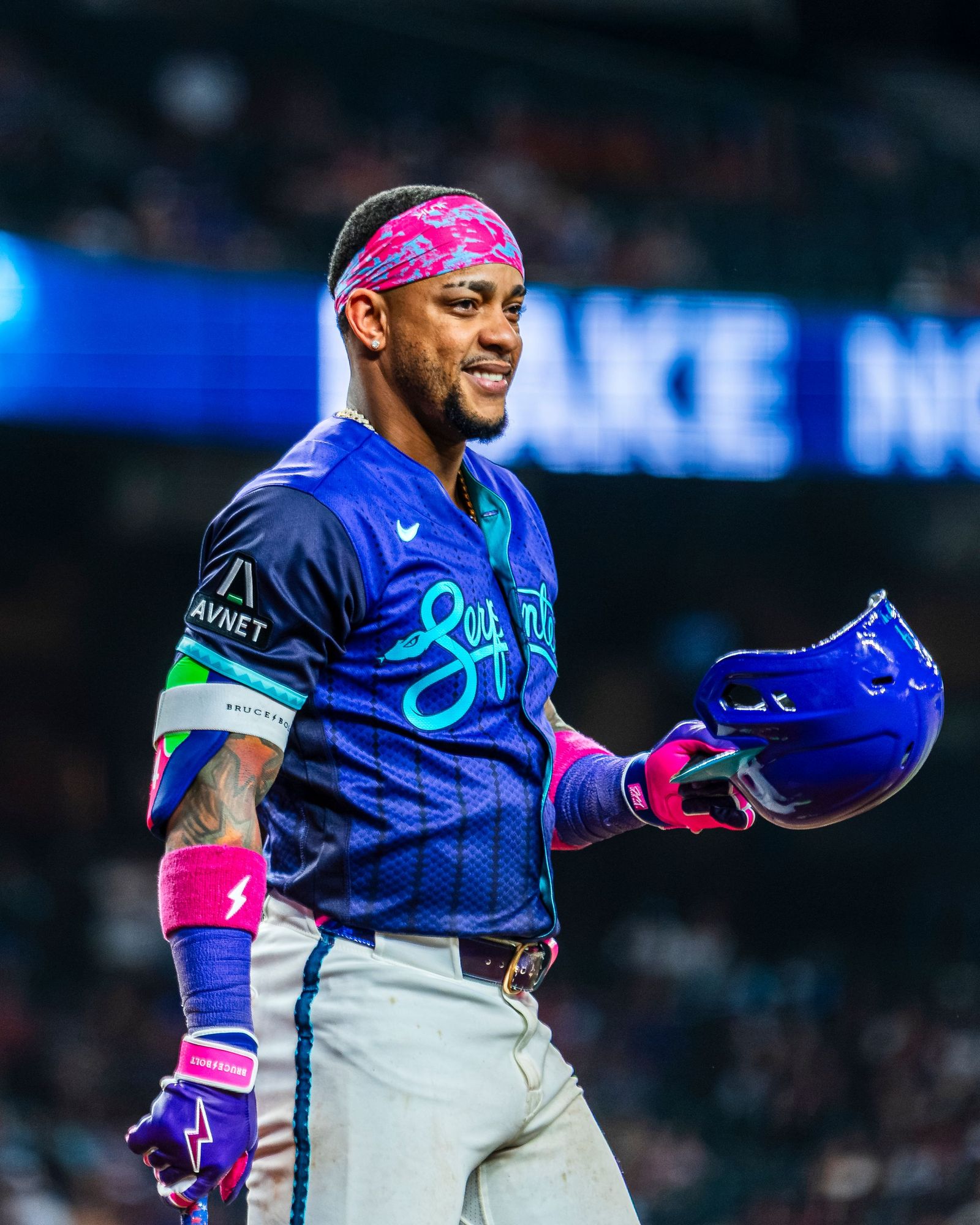 Round Rock Express player in a blue alternate jersey and pink bandana