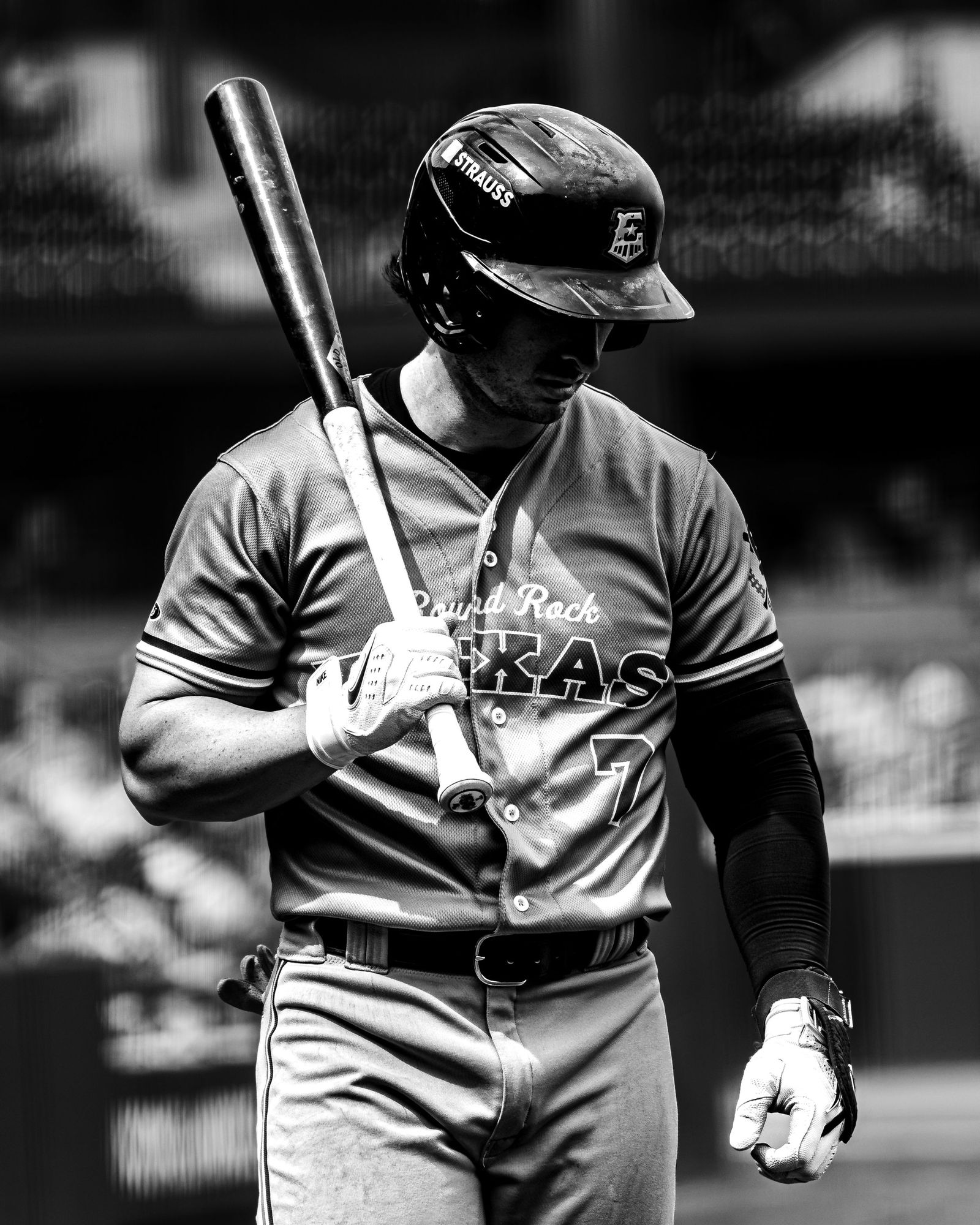 Round Rock player holding a bat, black and white