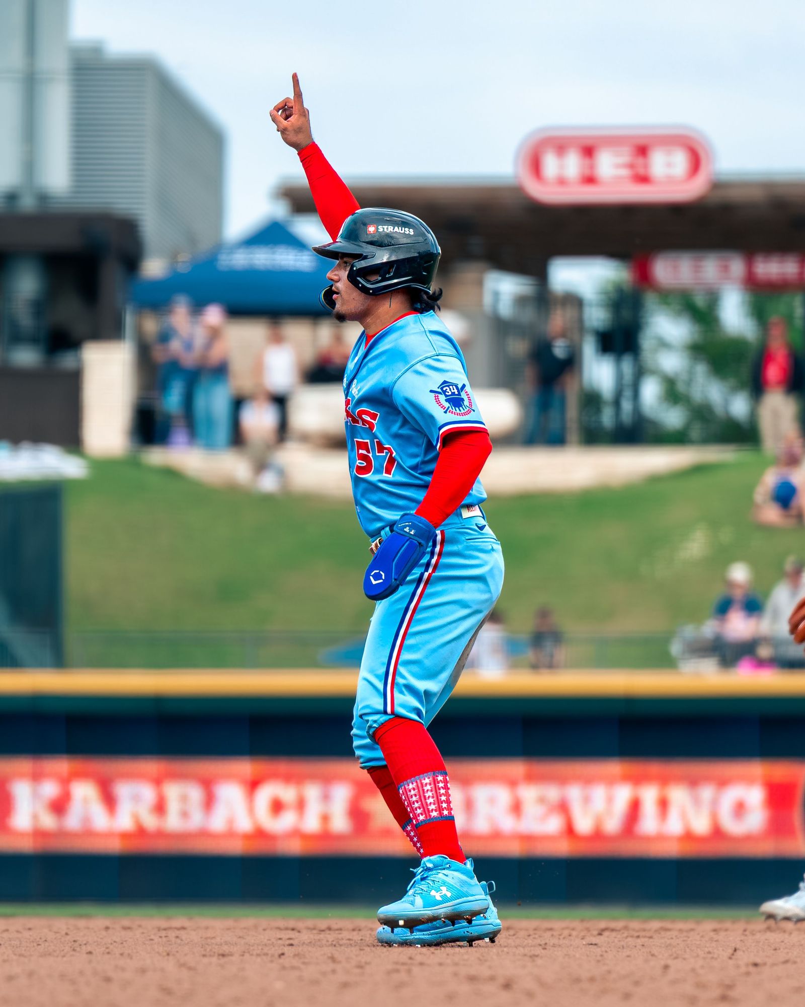 Texas number 22 pointing skyward as he rounds the bases