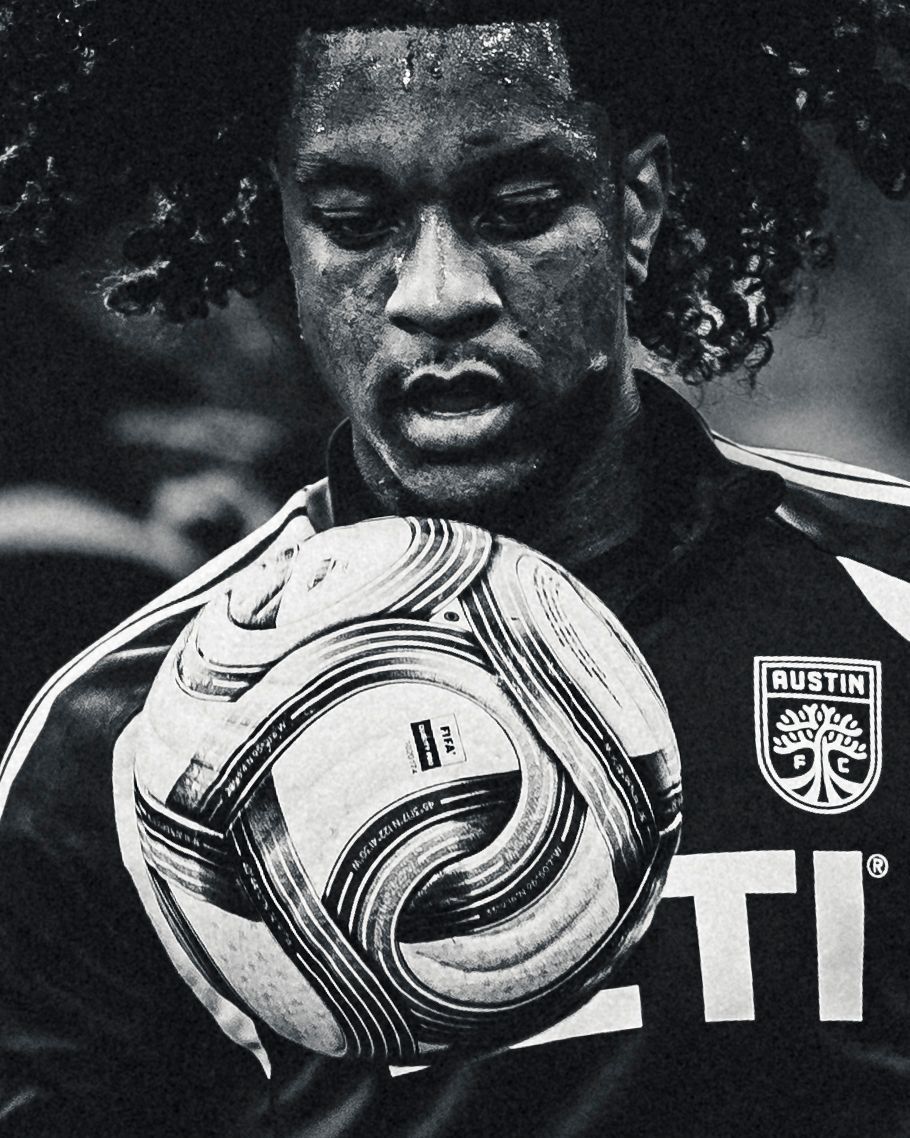 Austin FC player holding the ball to his chest, black and white