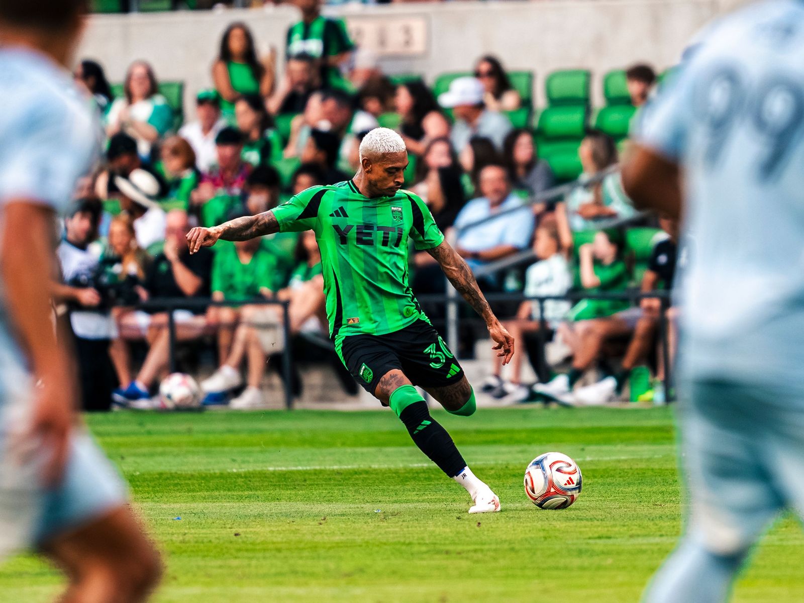 Austin FC player striking the ball