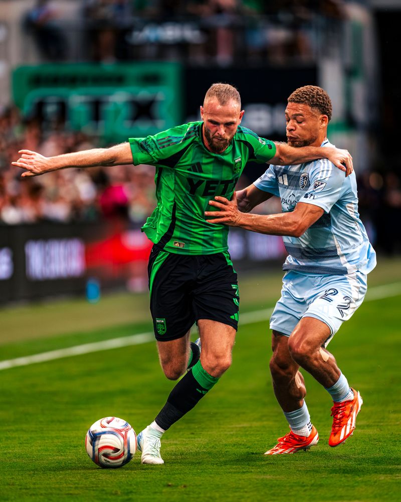Austin FC player shielding the ball from a defender