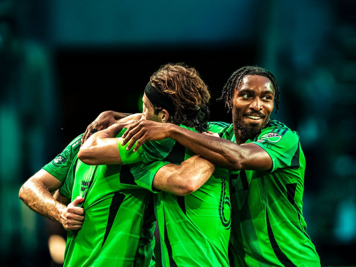 Austin FC players embracing after a goal