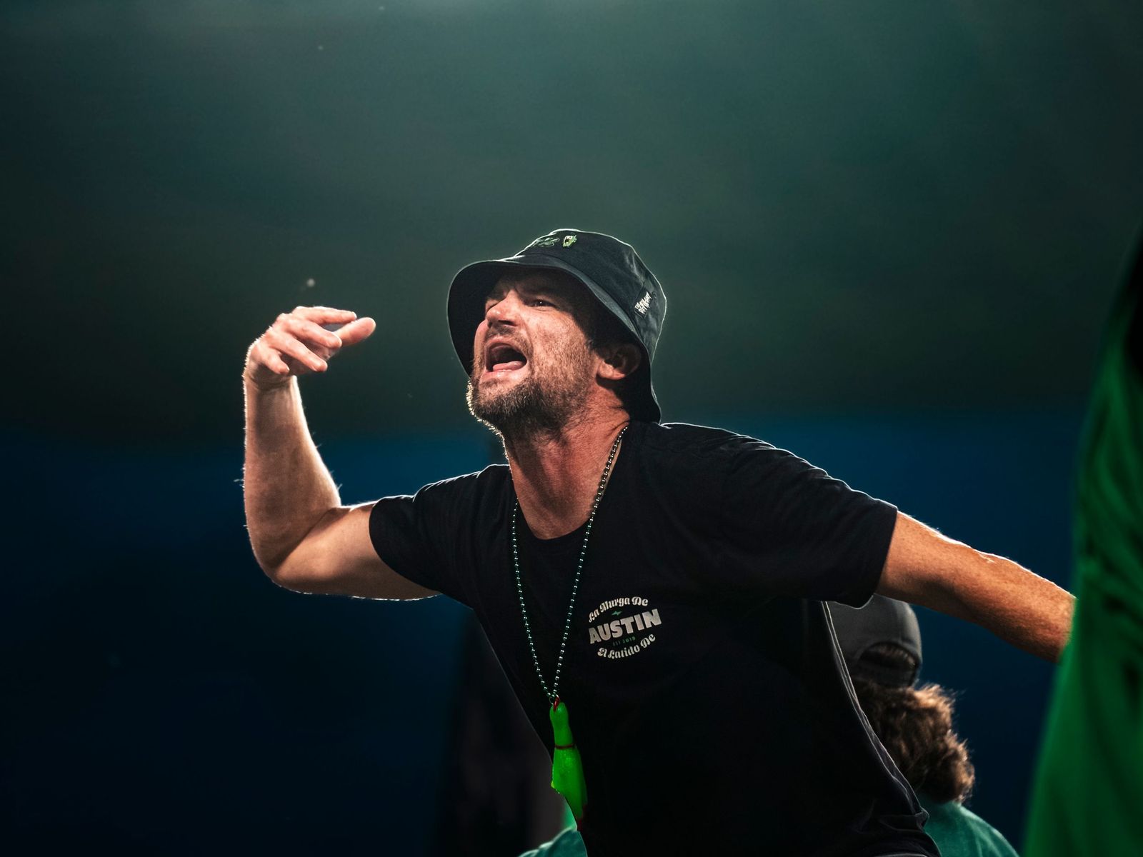 Fan in a bucket hat shouting from the stands