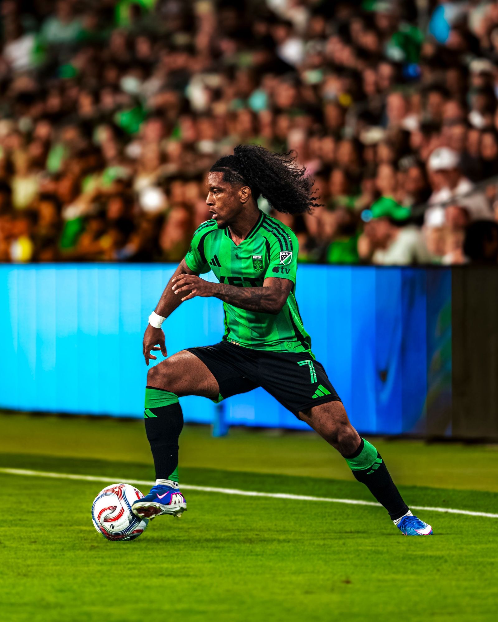 Austin FC player dribbling at speed