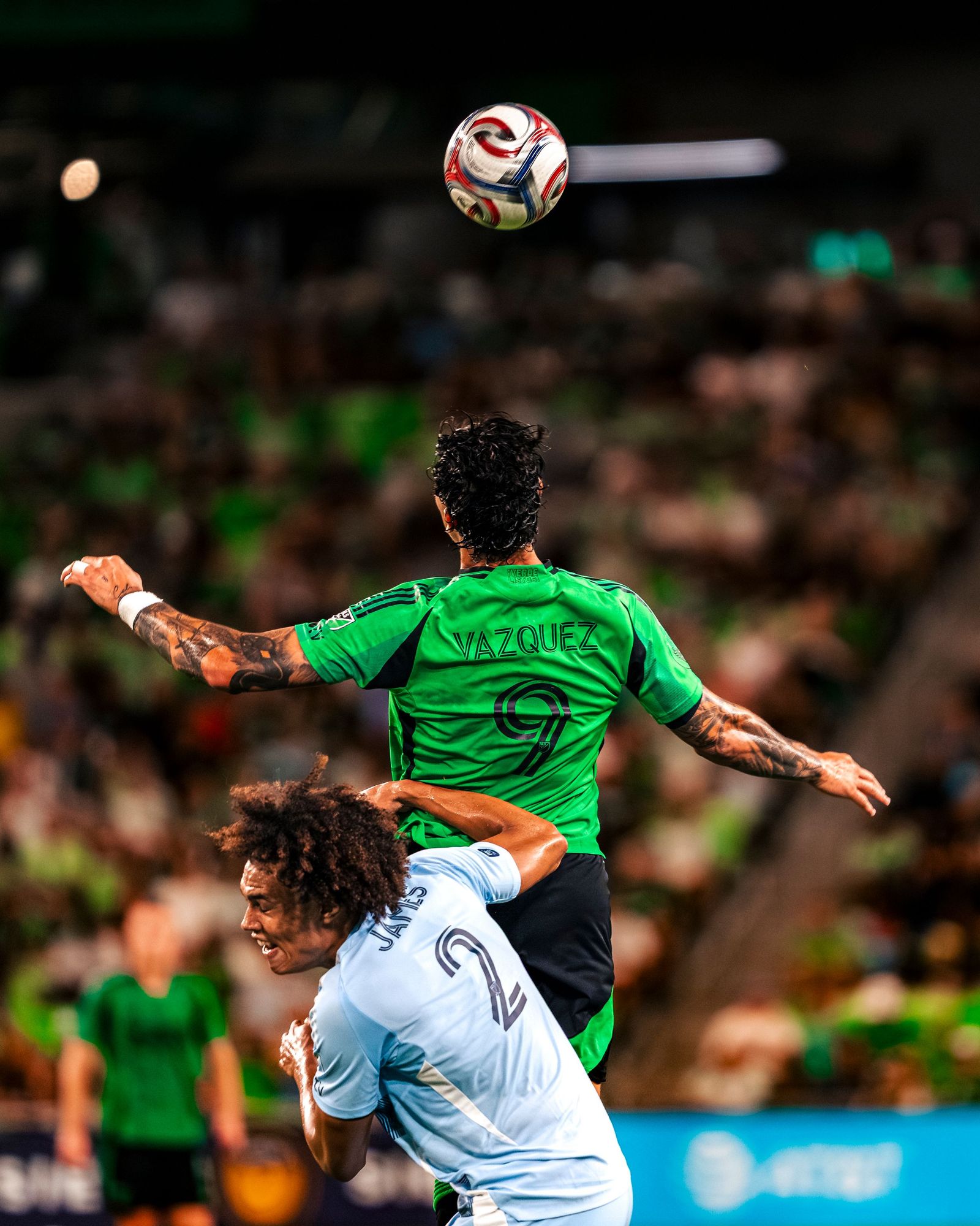 Austin FC player rising for a header