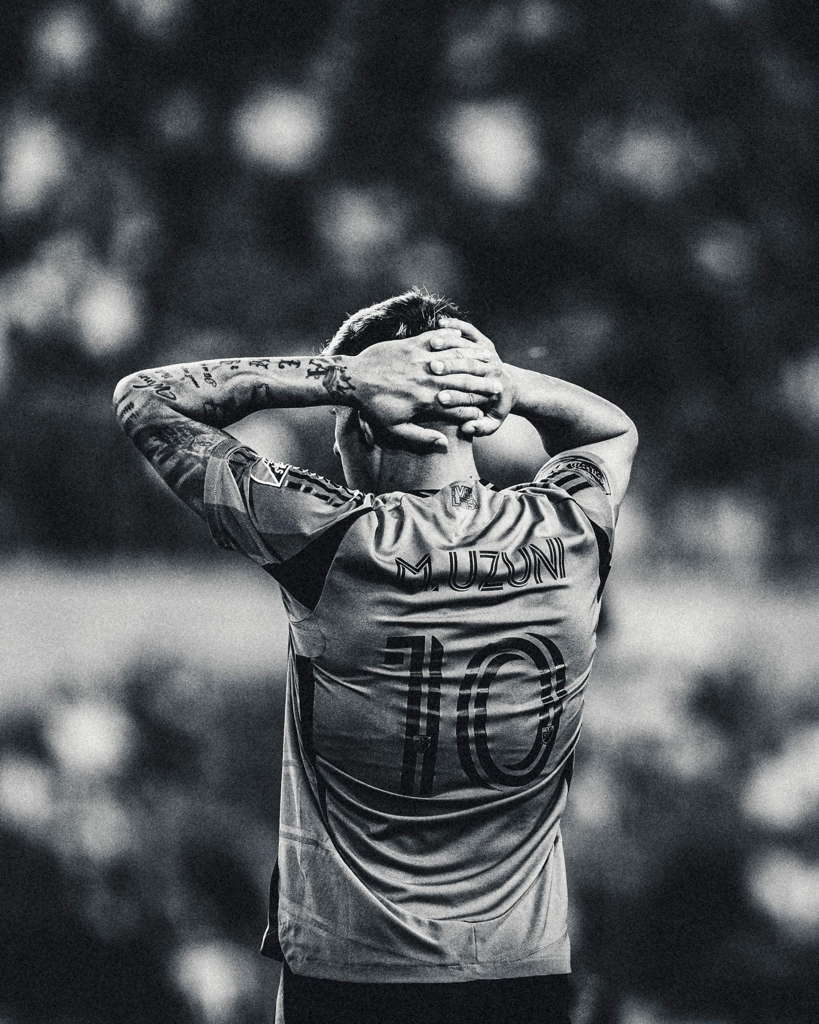 Player number 10 with his hands on his head, black and white