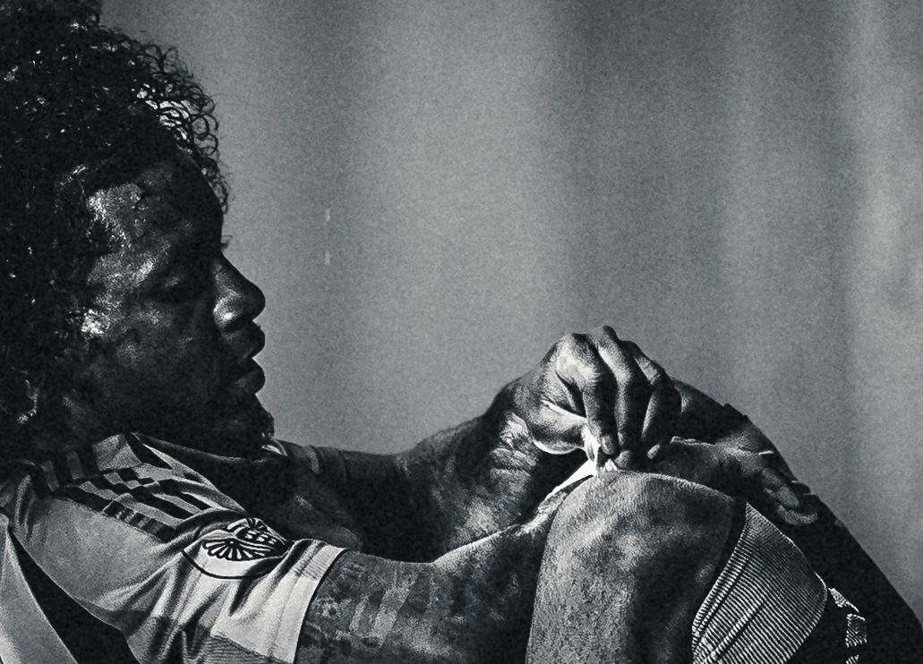 Player gripping his jersey, black and white