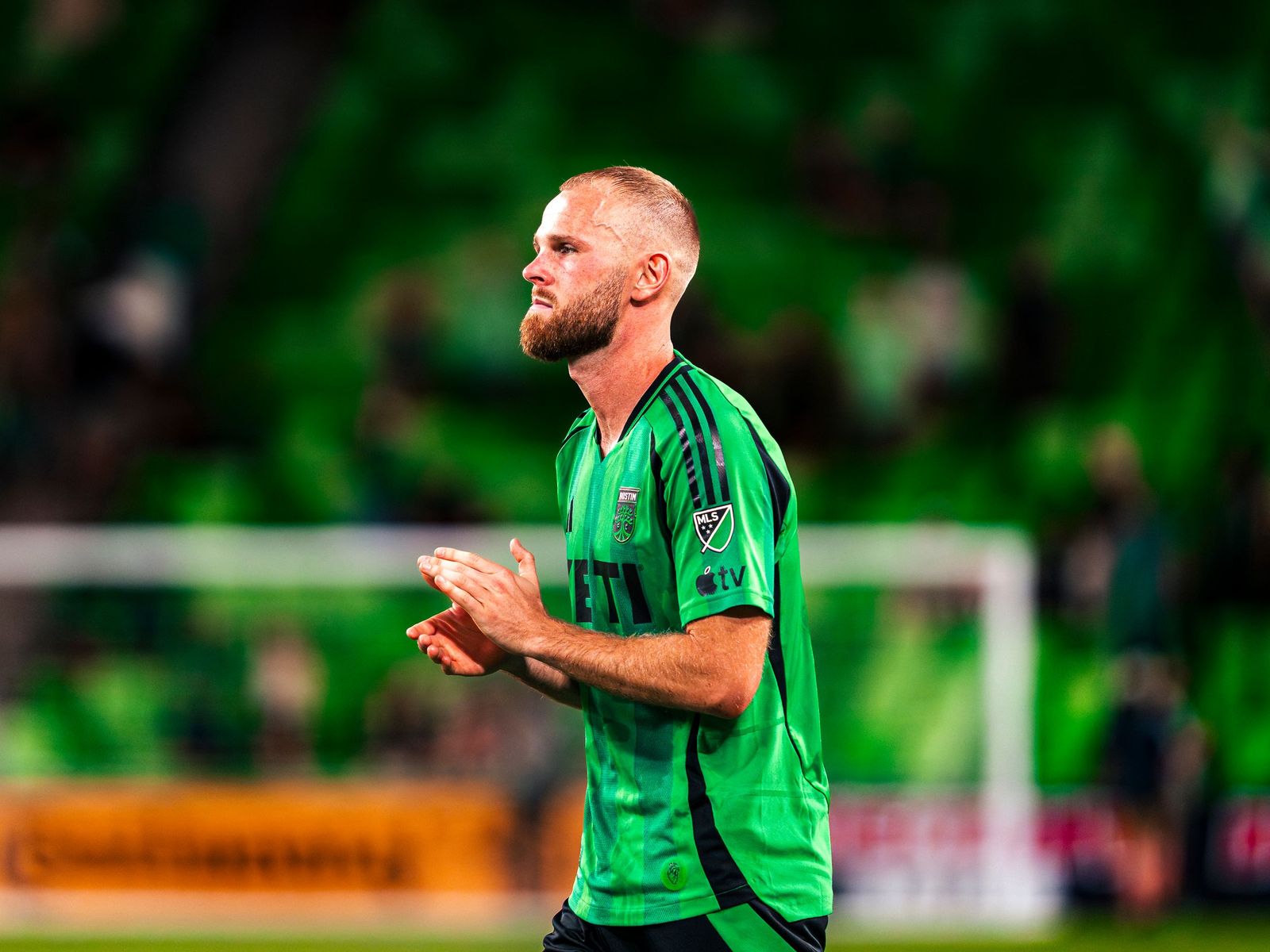 Austin FC player applauding the supporters
