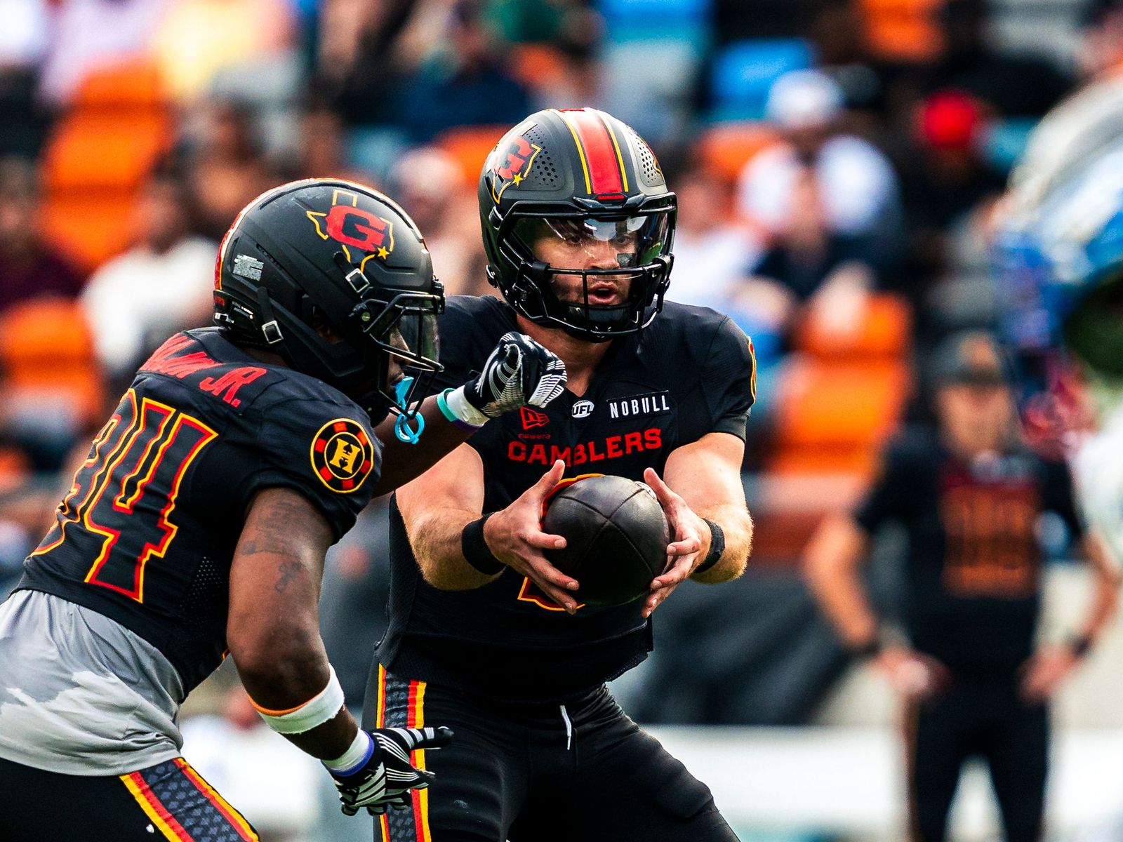 Houston Gamblers quarterback handing off