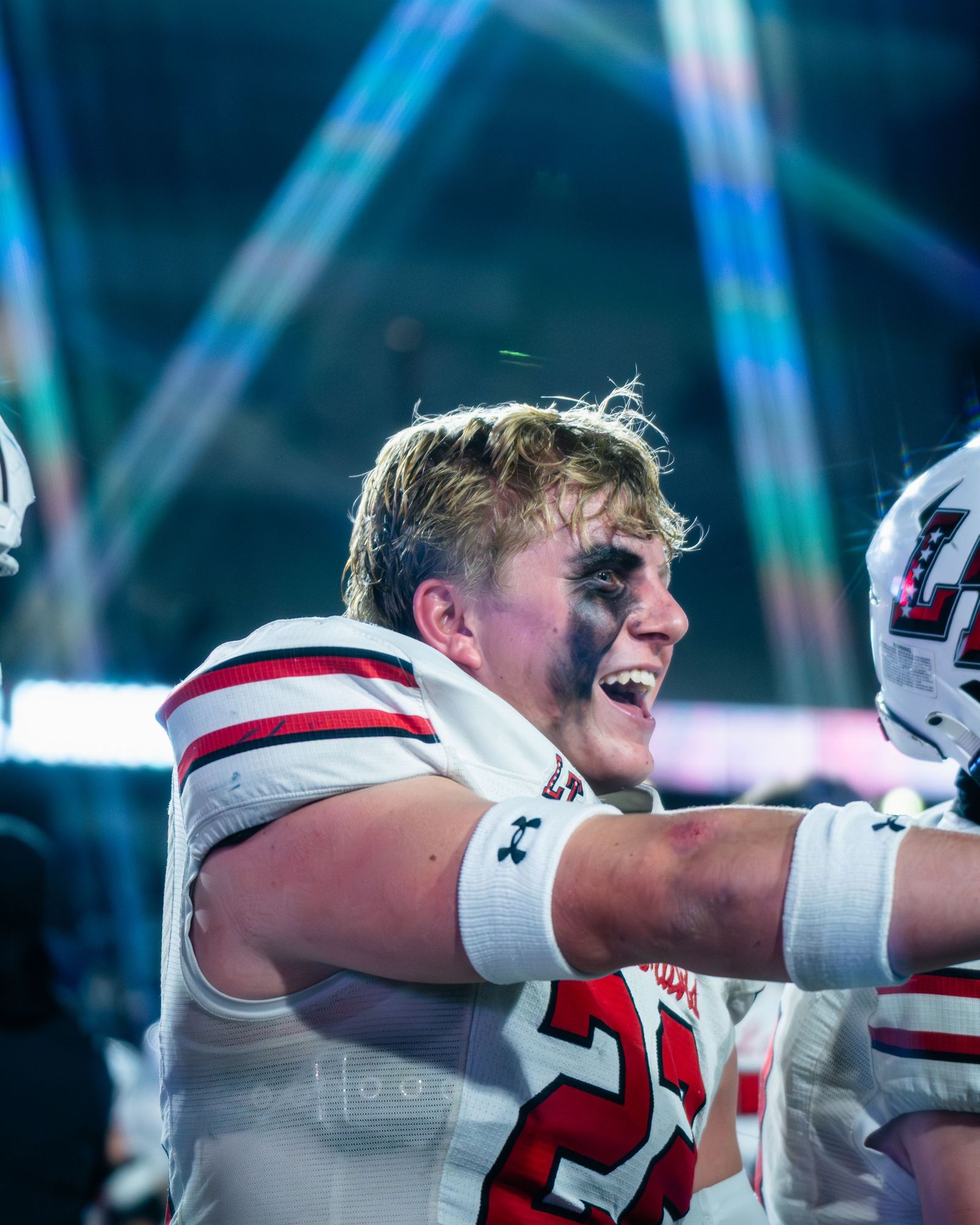 Lake Travis player laughing on the sideline