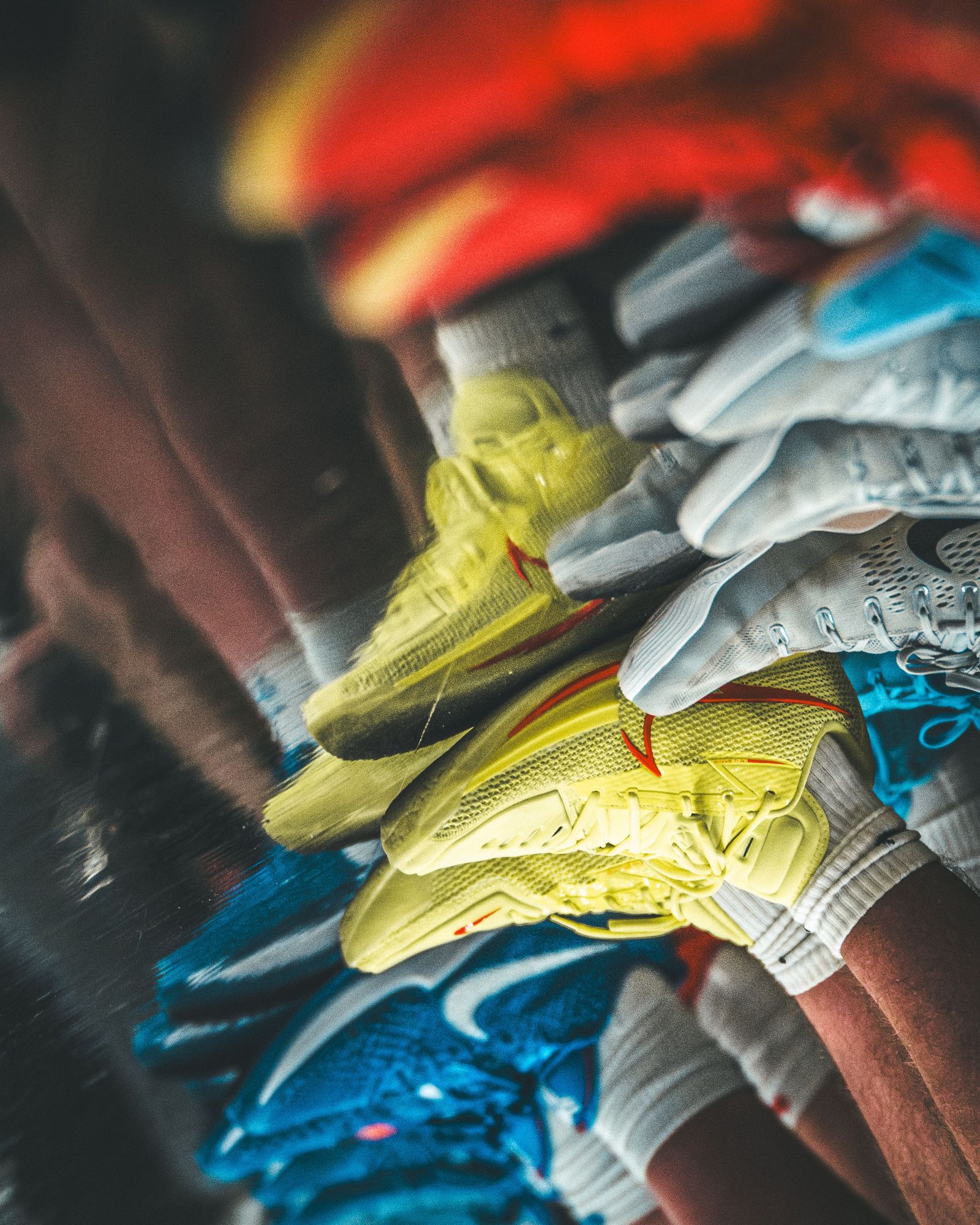 A stack of yellow gloves and cleats