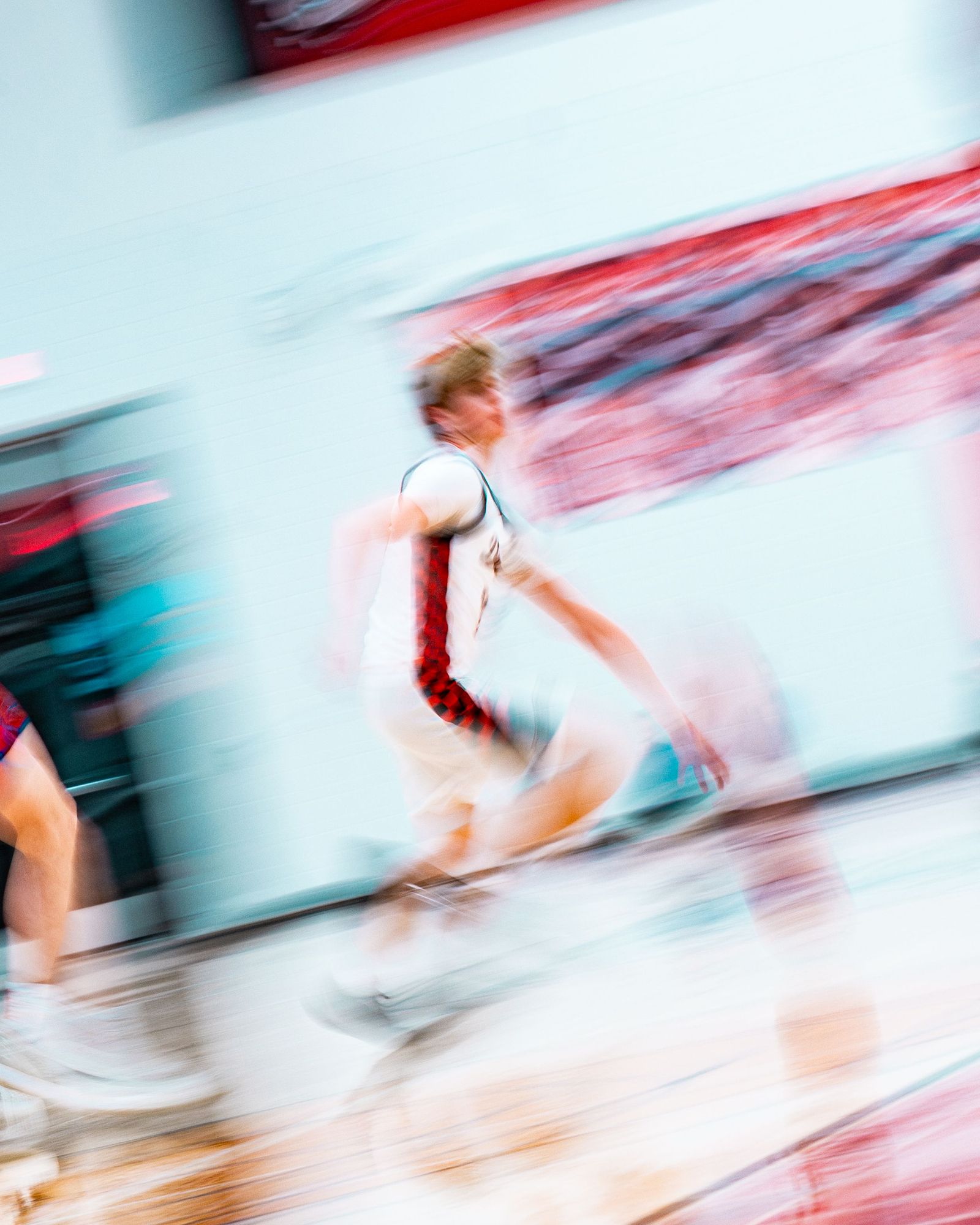 Basketball player streaking upcourt in a blur