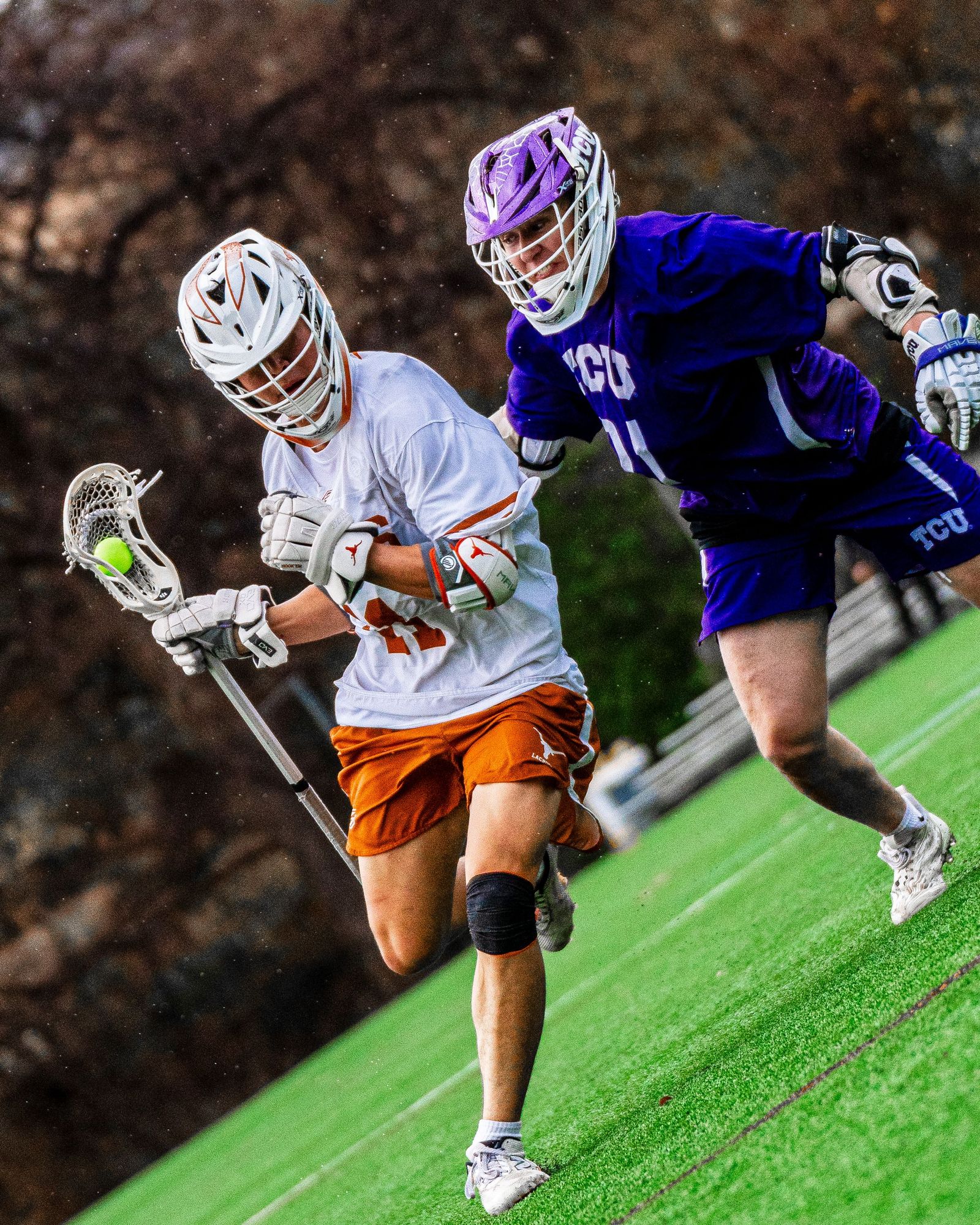 Texas lacrosse player battling a TCU defender