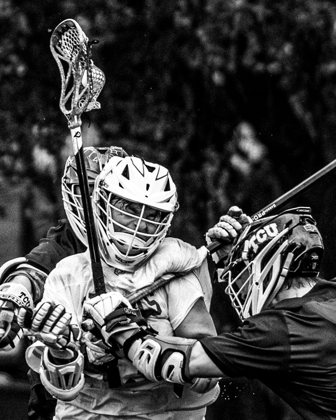 Lacrosse players fighting for the ball, black and white