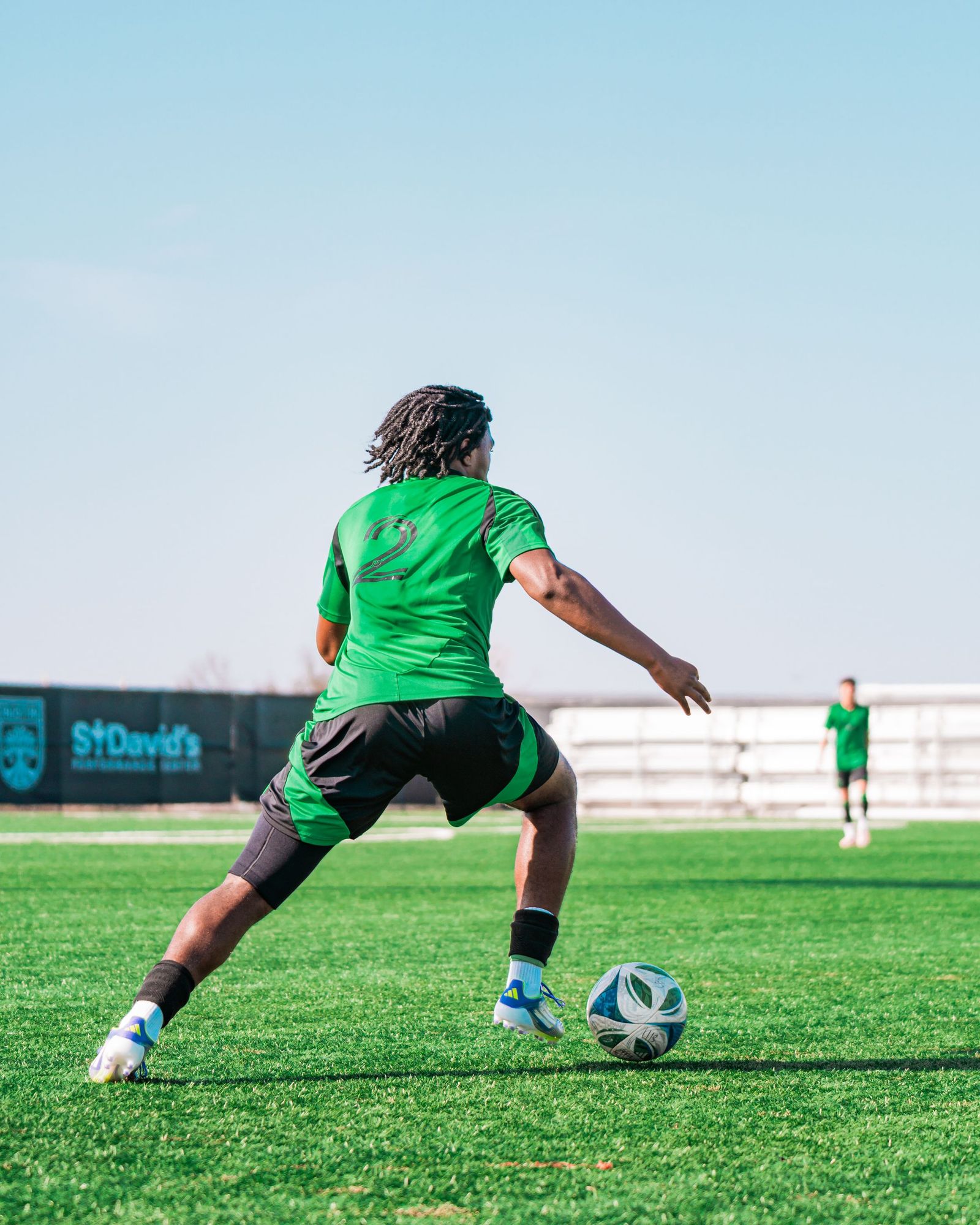 Austin FC academy player seen from behind with the ball