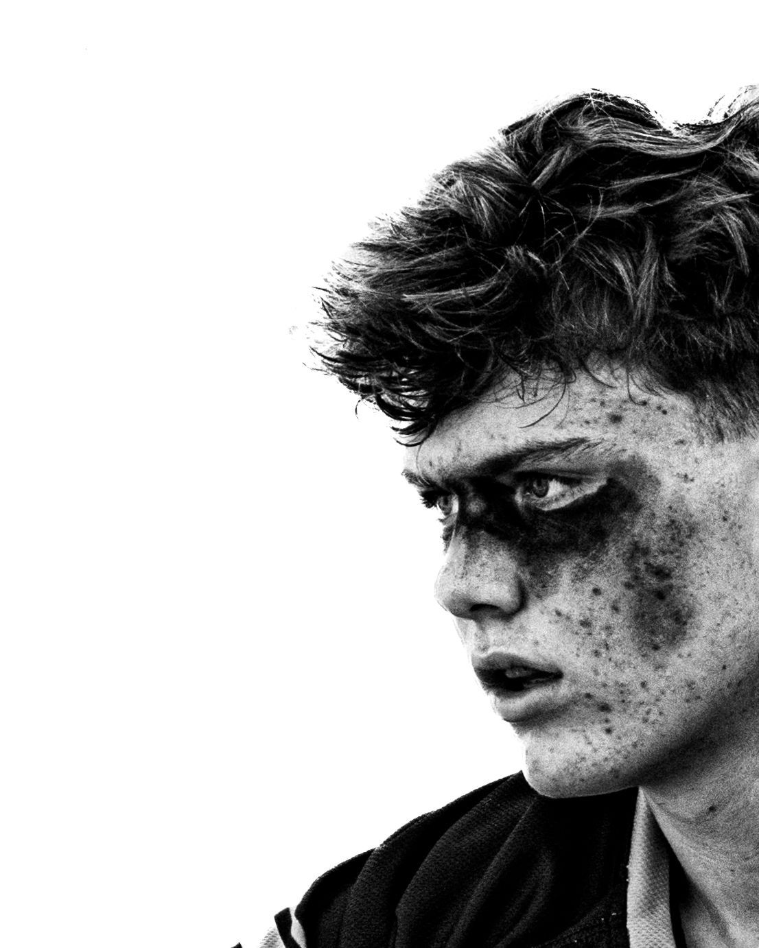 Lacrosse player with eye black staring into the distance, black and white