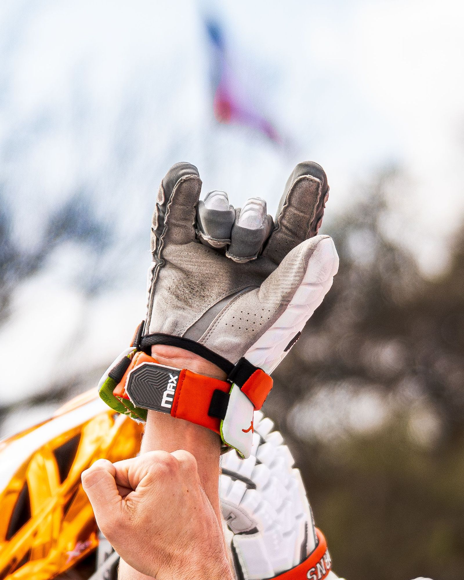 Lacrosse player raising gloved hands