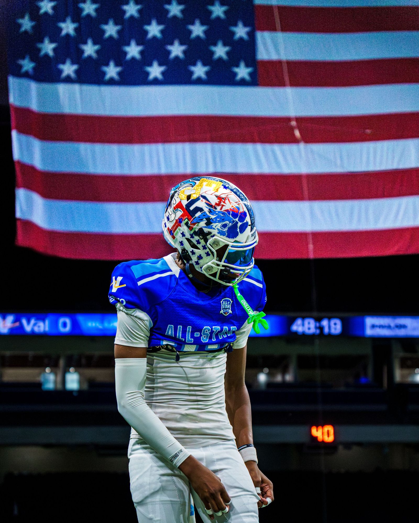 All-star football player looking up at an American flag