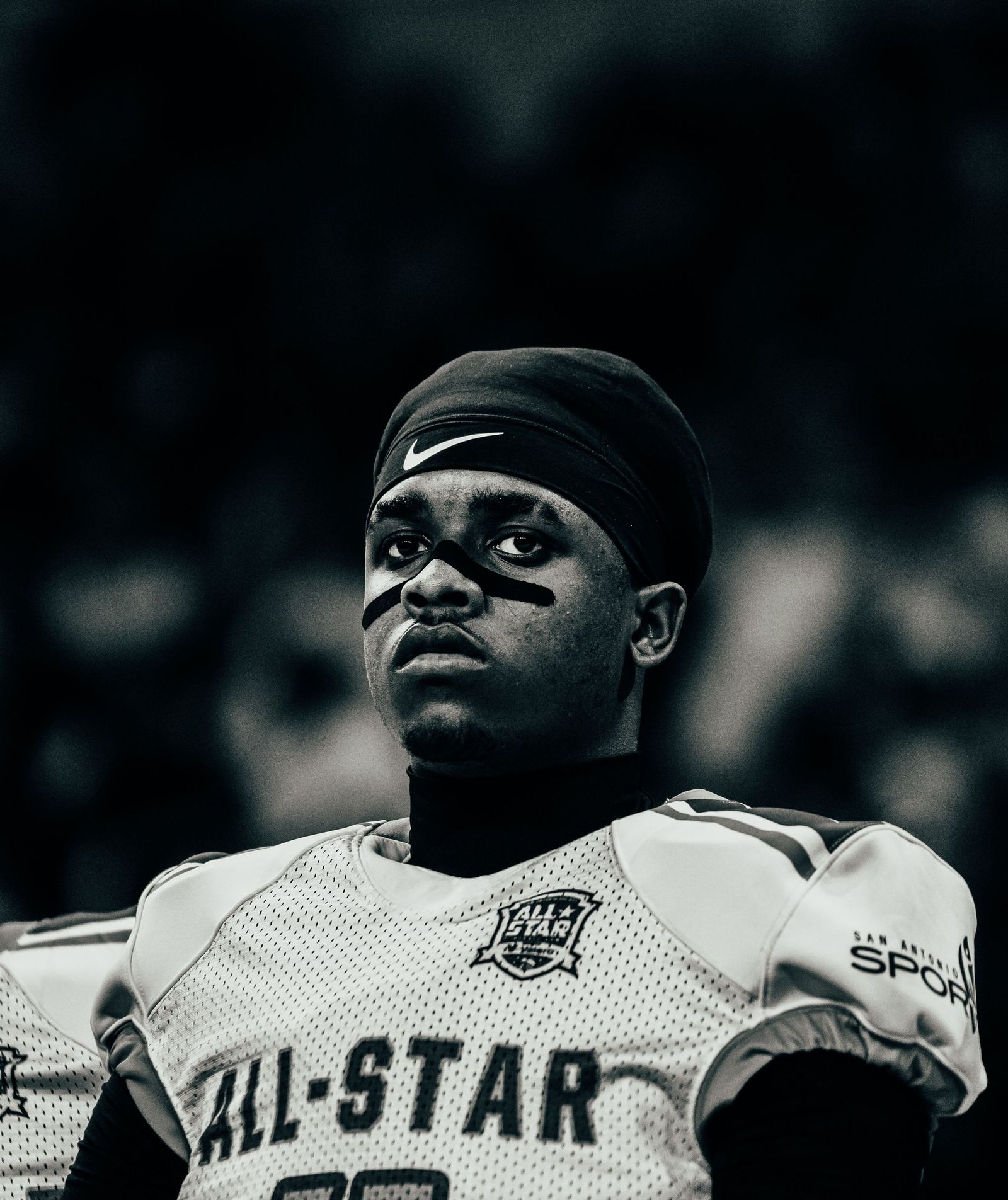 All-star football player under the lights, black and white