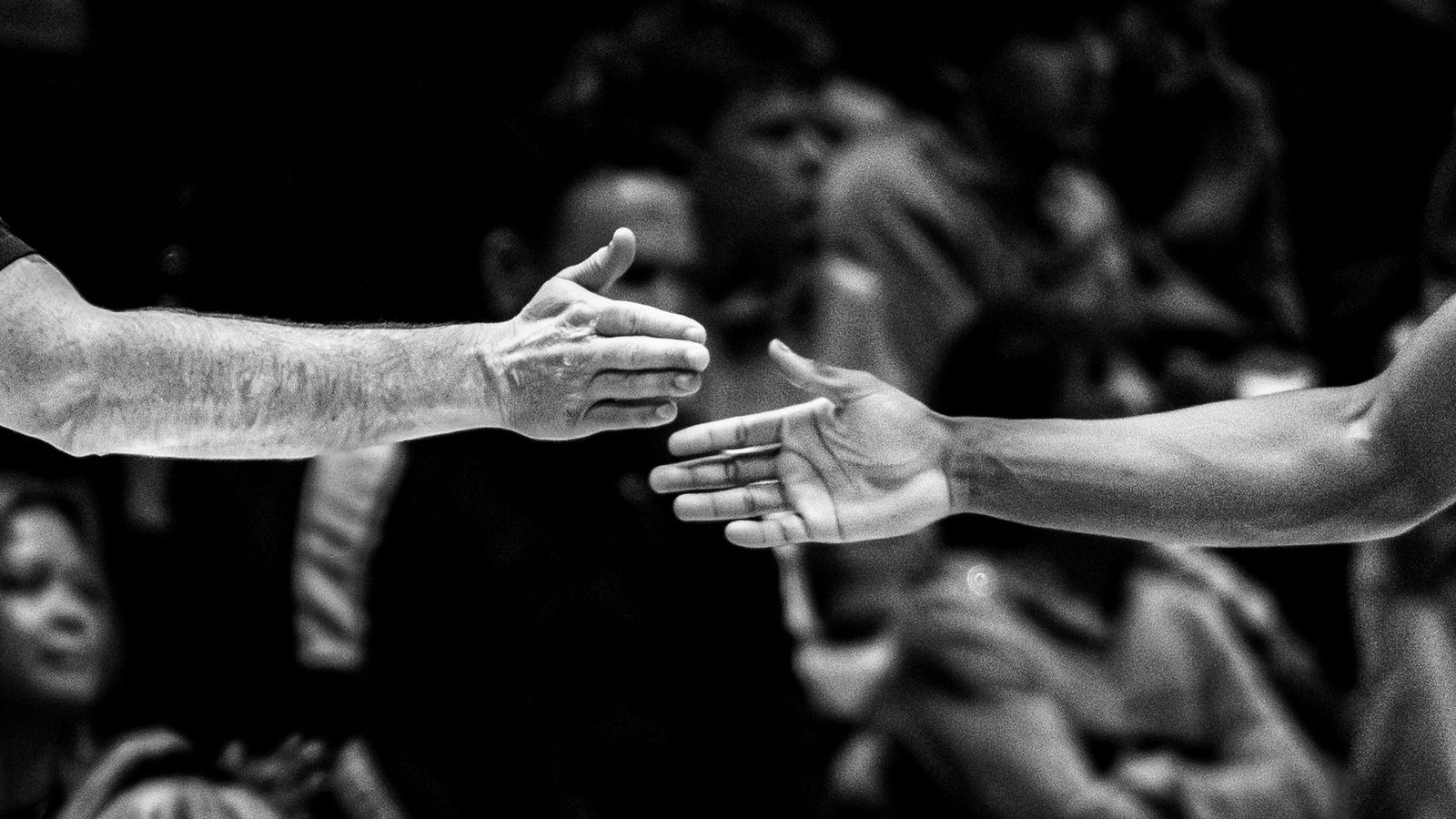 Two hands about to shake, black and white