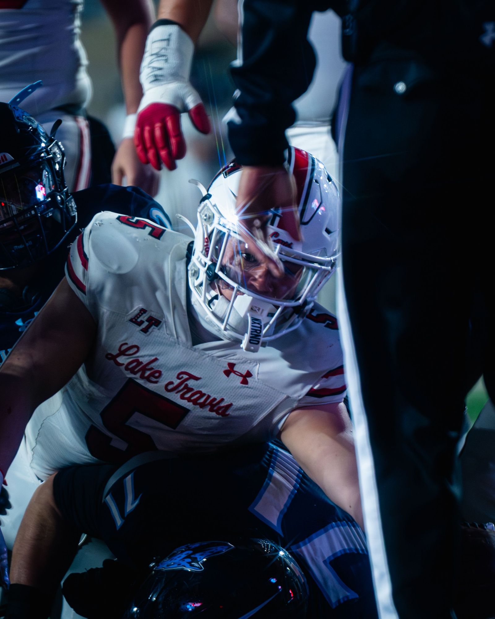 Lake Travis football players piling on in celebration